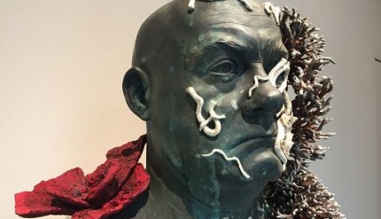 Venezia, 7 apr. (askanews) - È tutto accaduto, più o meno. Rubiamo uno dei più noti incipit dello scrittore Kurt Vonnegut per provare a descrivere ciò che si prova entrando nella nuova e stupefacente mostra di Damien Hirst, "Treasures from the Wreck of the Unbelievable", allestita a Venezia sulle due sedi di Palazzo Grassi e Punta della Dogana. 

Un'esperienza di scoperta o, meglio, riscoperta del lavoro di uno dei più grandi artisti contemporanei nella quale ci si imbatte in una serie vertiginosa di diversi livelli di realtà e di diverse possibili verità, ricordando che la verità, recita una scritta quasi dantesca all'ingresso della mostra, giace da qualche parte tra le bugie e il vero (in inglese il gioco di parole tra lies-bugie e lies-giacere è decisivo). Osservando le poderose sculture riemerse dal naufragio dell'incredibile, e quindi addentrandoci nel terreno dove l'incredulità non ha più cittadinanza, si ha la sensazione di non ritrovare più Damien Hirst che conoscevamo, ma a fine percorso invece è come se lui fosse sempre stato lì, addirittura amplificato. 

La curatrice della mostra, Elena Geuna: "L'artista - ci ha detto - è anche un grande collezionista e quindi qui ha voluto in un certo senso trasformarsi completamente ed è questo che rende gli artisti grandi, la capacità di creare ex novo, la capacità di sorprendere e innovare. Sicuramente questa mostra non lascerà incerte le persone, c'è chi se ne innamorerà e ci sarà qualcuno che non la capirà, ma la cosa fondamentale per l'artista è permettere che i visitatori si pongano delle domande".

Domande che ruotano intorno alla costruzione narrativa che Hirst ha immaginato, documentato, e ammantato di realtà, con tanto di prove filmate: ossia il ritrovamento del mitico tesoro del collezionista Cif Amotan, naufragato millenni fa e riemerso e preso in consegna dall'artista, che ora lo mette in mostra. Una narrazione che è parte essenziale della mostra e che genera una idea nuova di arte, pur lasciando aperte delle falle attraverso le quali, direbbe gente come William Blake, Borges o Philip Dick, intuire un'altra verità, che però è sempre la penultima, mai - grazie al cielo - quella definitiva. E in queste falle troviamo, accanto a una statua colossale dentro Palazzo Grassi, anche reperti marchiati Walt Disney, o un autoritratto dell'antico collezionista che fa da specchio allo stesso Hirst.

"Le tematiche - ha aggiunto la curatrice - sono quelle che lui declina da vari decenni, ma fatte in modo completamente diverso, usando dei materiali nuovi, usando delle mitologie del passato, riscritte nel presente e forse con più delicatezza rispetto a come lui aveva fatto all'inizio degli anni Novanta".

Mitologie che sono molteplici, vere e false al tempo stesso, come le sensazioni, completamente diverse, che allo spettatore capita di provare nei vari momenti dell'esposizione, dove dalla serietà si passa alla facezia, e poi all'inverso, senza mai perdere però quel senso di stupore e di novità che elettrizza (e rende più complesso) ogni passo. Ma sono passi che vale la pena provare a fare, per sentire quella sensazione, sempre per citare il visionario Blake, di "matrimonio del cielo e dell'inferno" che forse mai avremmo pensato di associare al ragazzo arrabbiato di Bristol Damien Hirst. 

E quando chiediamo, prima di congedarci, a Elena Geuna, quale verità ci portiamo via da Venezia, la curatrice risponde così: "Che si può continuare a sognare e che è permesso credere ai miti e che l'arte esiste, si rinnova e continua a permettere all'umanità di progredire".